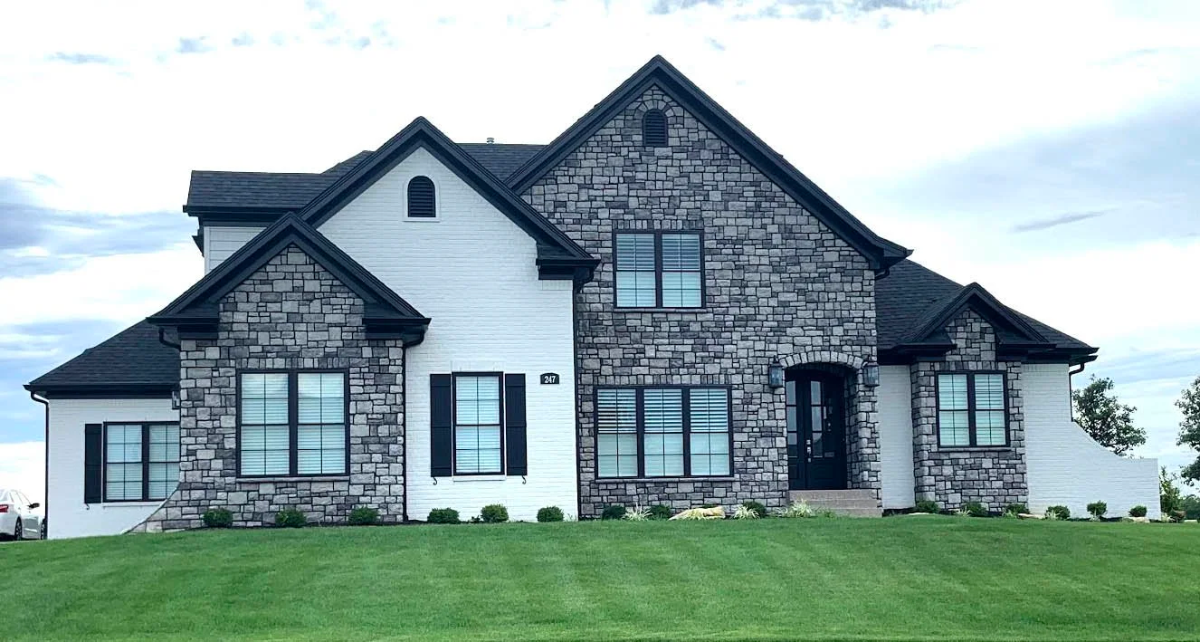 Two-story home with Mountain Stone veneer gables and white brick