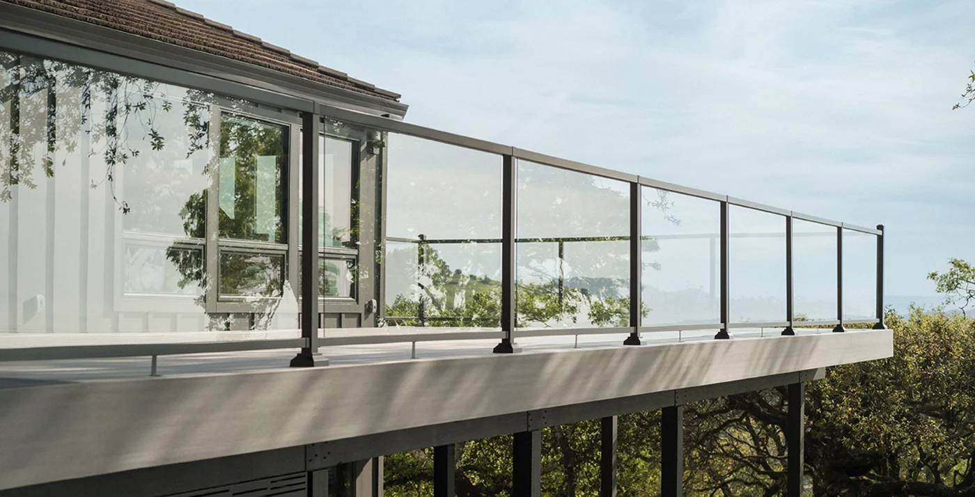 TimberTech deck with glass railing overlooking the treeline