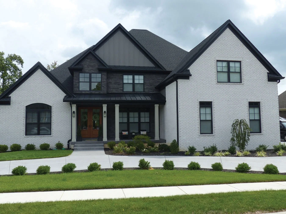 Home with white thin brick and dark Veneerstone ledge accent gable