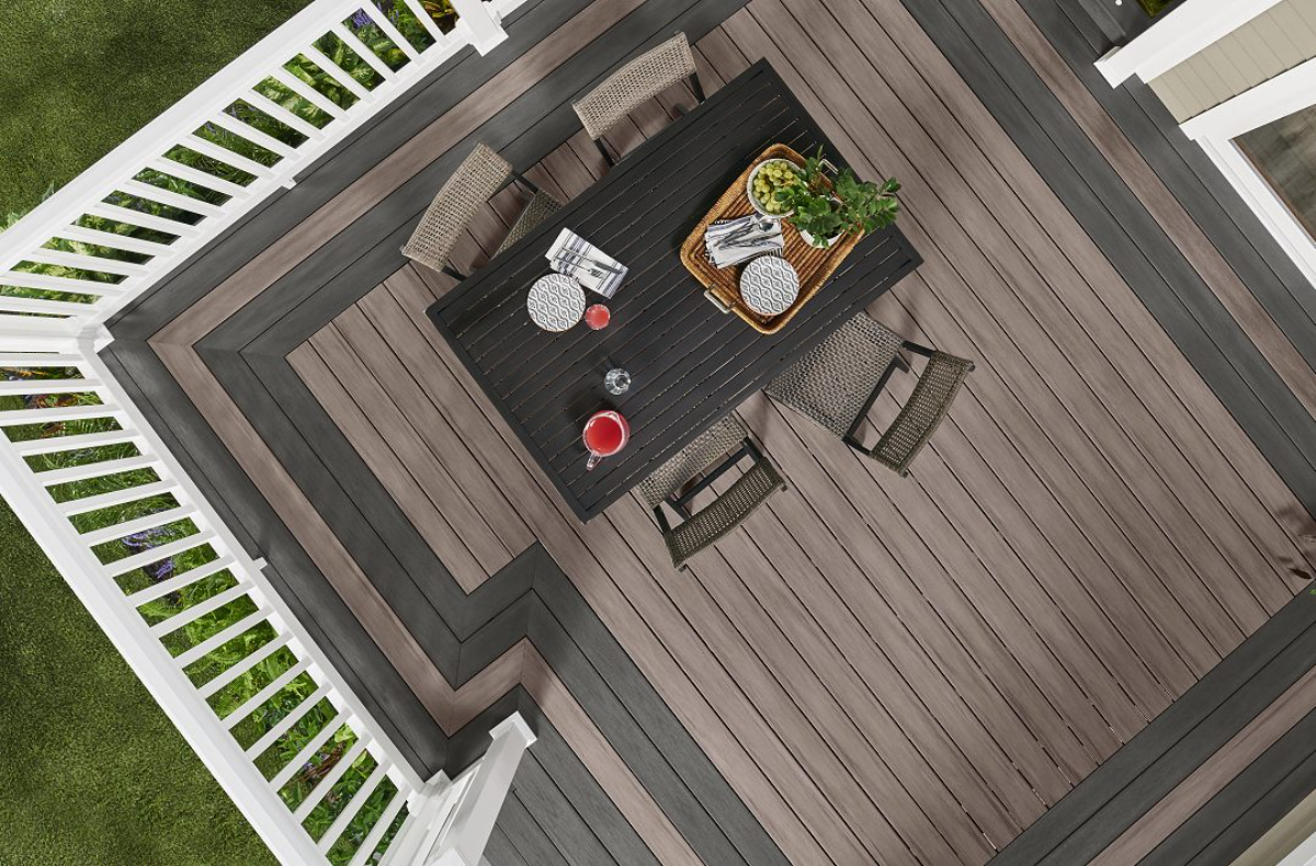 Overhead view of a two-tone Wolf composite deck with picture-frame border and white railing